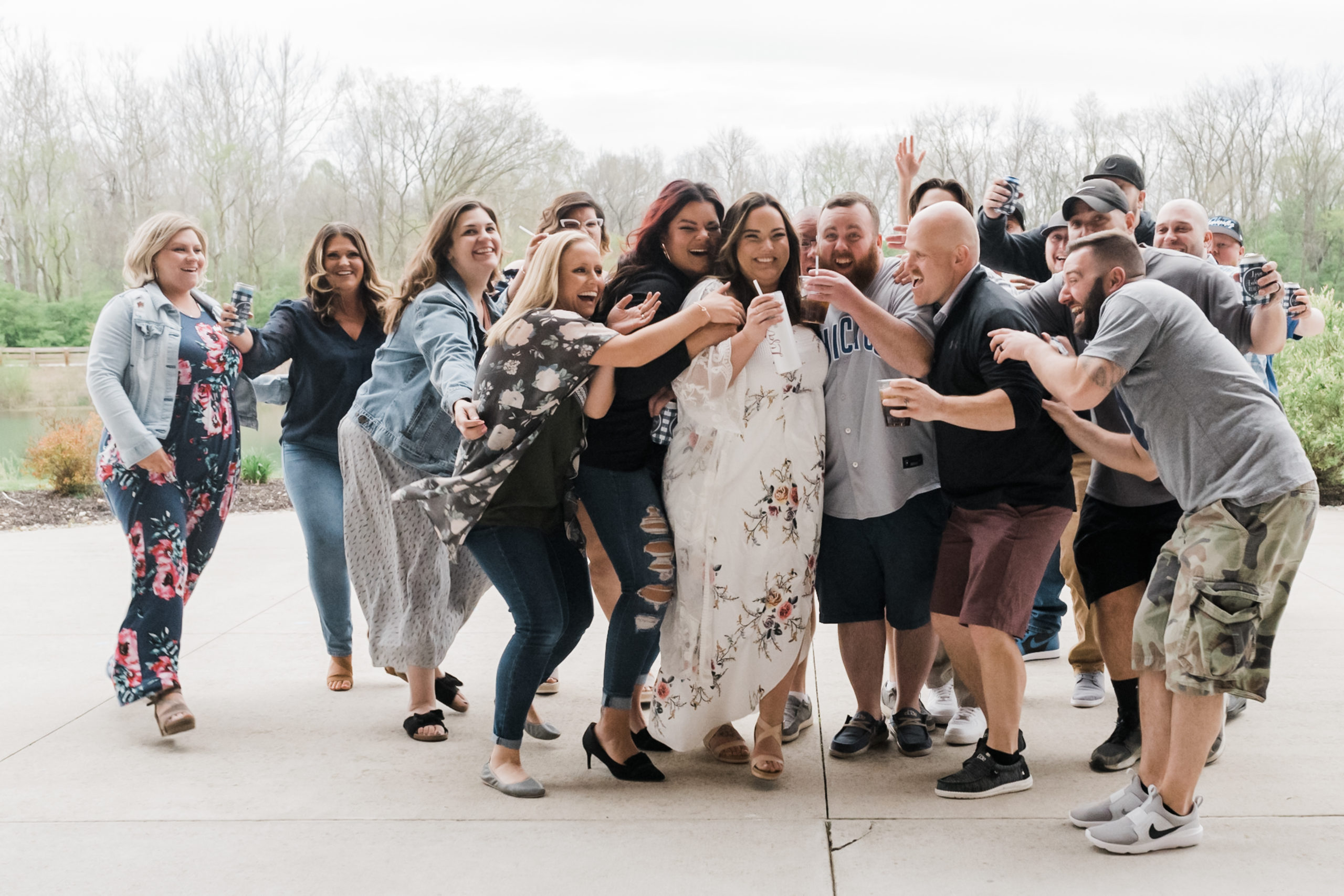 Bride and group celebrate with their wedding party at the rehearsal dibber.