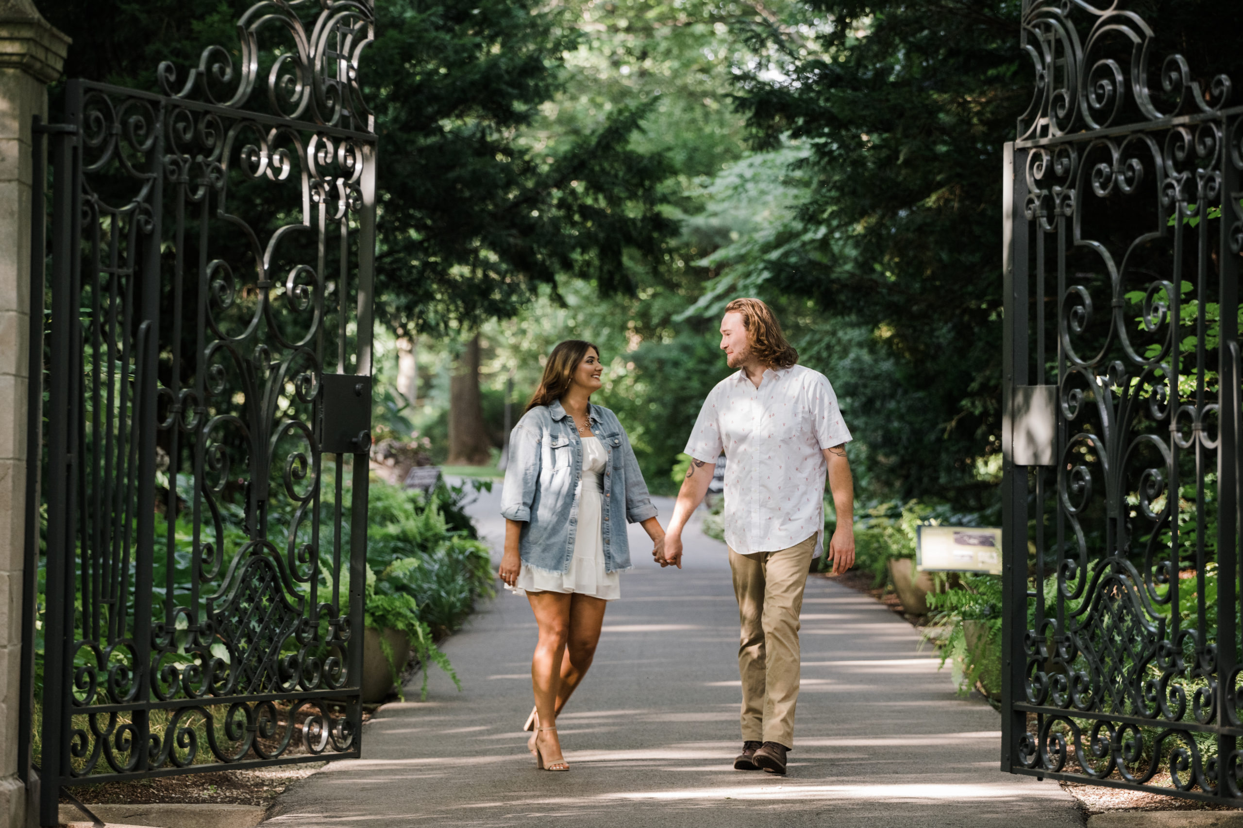 Engaged couple walking through the gates during their session at Newfields.