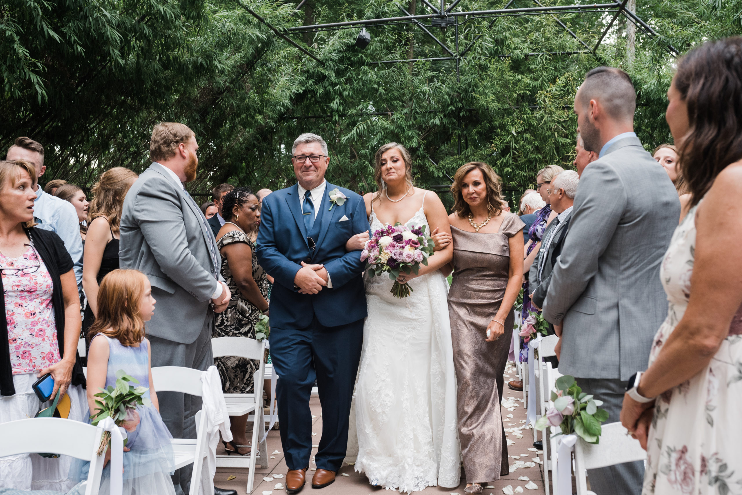 Bride walking down the aisle escorted by both parents Black Iris wedding Carmel, Indiana